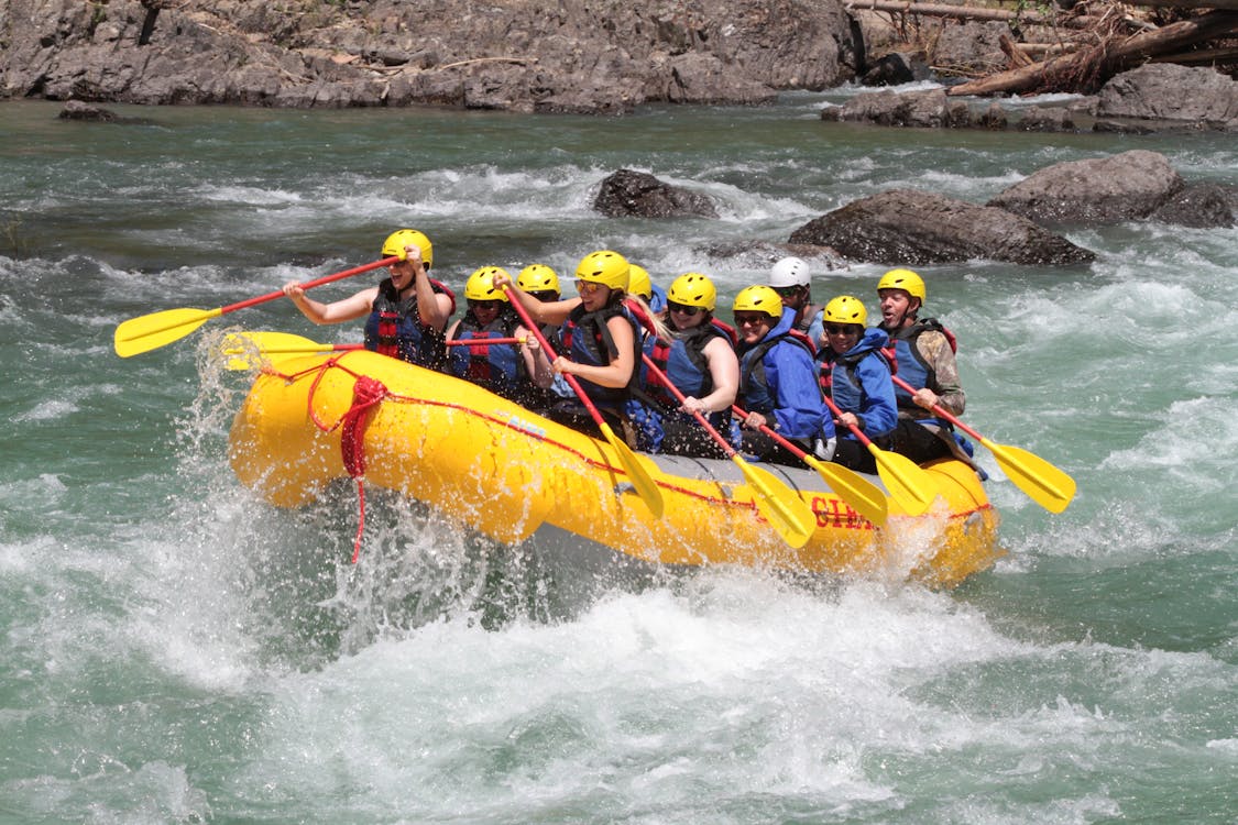 people with helmat rafting